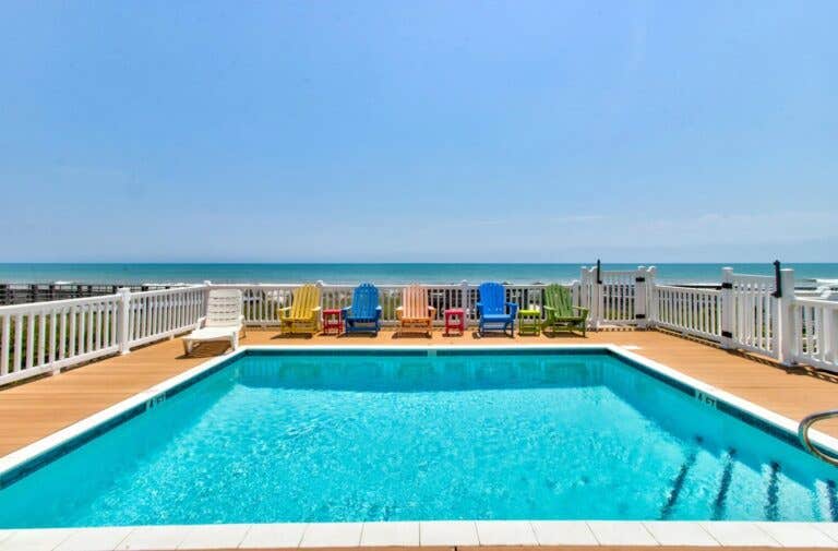 Oceanfront pool with colorful beach chairs